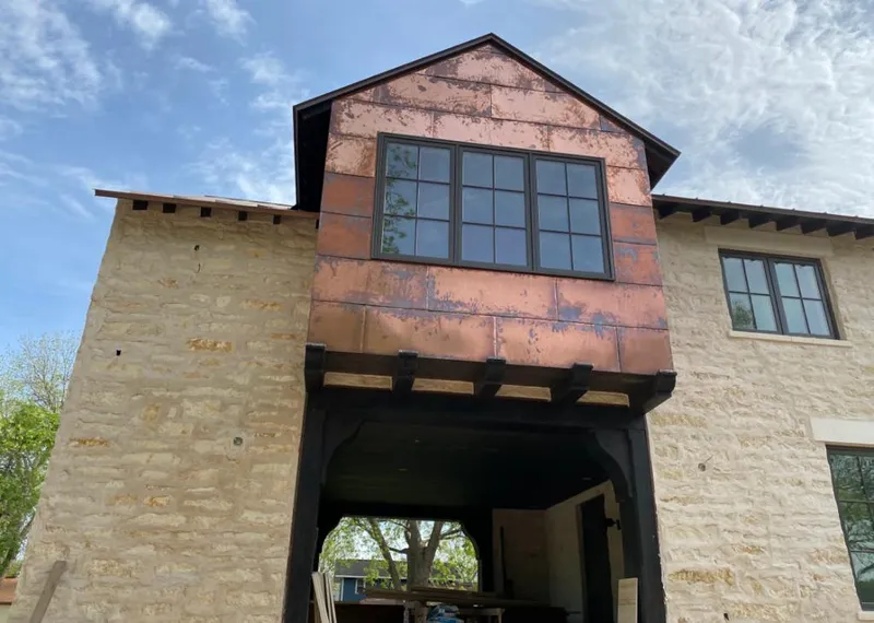 Copper metal panel facade on a stone building for Roof Repair in Perris